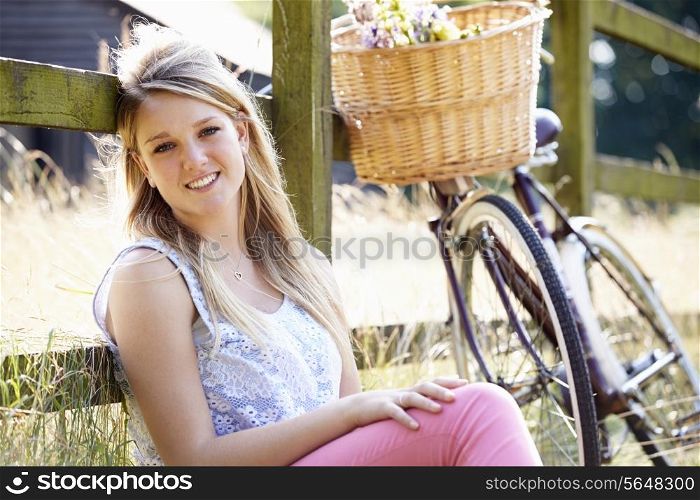 Attractive Woman Relaxing On Cycle Ride In Countryside