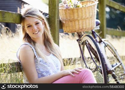 Attractive Woman Relaxing On Cycle Ride In Countryside