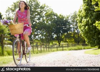 Attractive Woman Riding Bike Along Country Lane