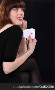 Attractive woman showing four aces