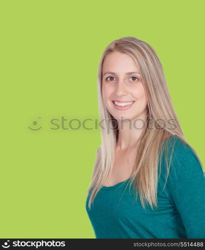 Attractive woman smiling on a green background