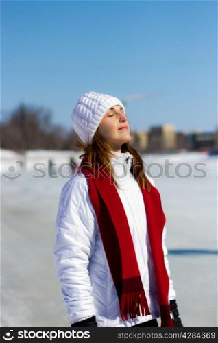 Attractive woman soaking in the sun during a cold winter