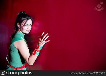 attractive woman standing and leans against the wall