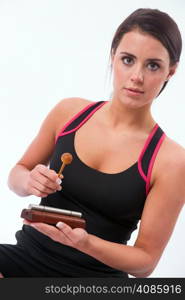 Attractive woman striking chime to bring an end to her meditation session