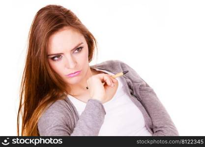 Attractive woman thinking seeks a solution, doubtful young female businesswoman holding a pen making decision, serious face expression. Woman thinking holds pen