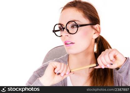 Attractive woman thinking seeks a solution, doubtful young female businesswoman wearing glasses holding a pen, serious face expression. Woman thinking holds pen