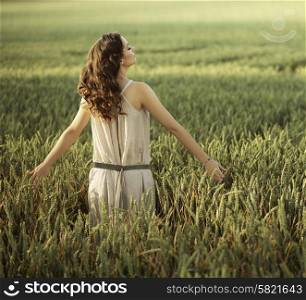 Attractive woman walking on the corn field