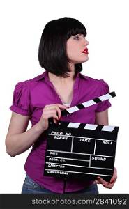 Attractive woman with a clapperboard