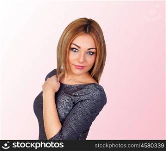 Attractive woman with a silvered dress isolated on pink background