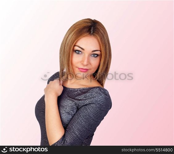 Attractive woman with a silvered dress isolated on pink background