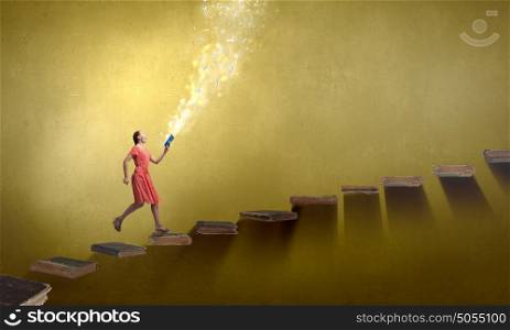 Attractive woman with book. Young woman in red dress running with book in hand