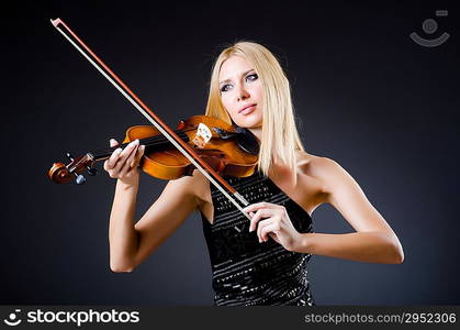 Attractive woman with cello in studio