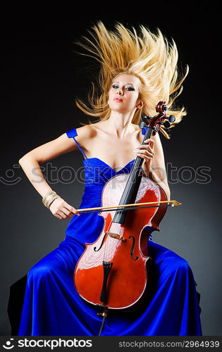 Attractive woman with cello in studio