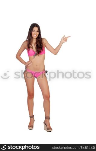 Attractive woman with pink swimwear indicating something isolated on a white background