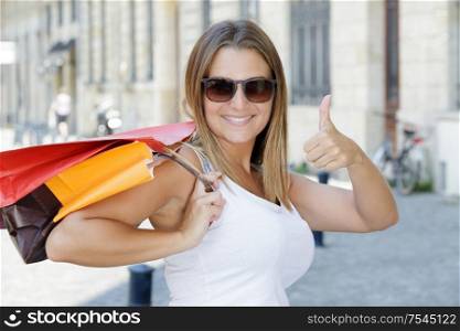 attractive woman with shopping bags outdoors