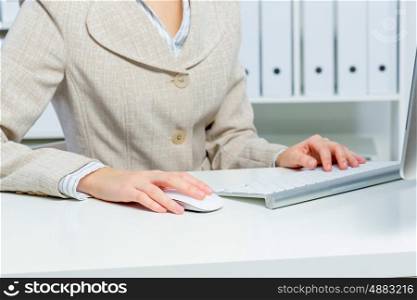 Attractive woman working in office on computer