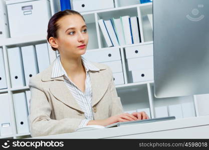 Attractive woman working in office on computer. Office work