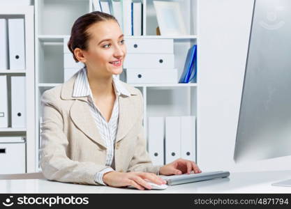 Attractive woman working in office on computer. Office work