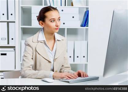 Attractive woman working in office on computer. Office work