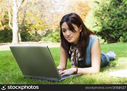 Attractive women on a laptop outside