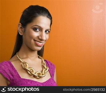 Attractive young adult Indian woman smiling at viewer.
