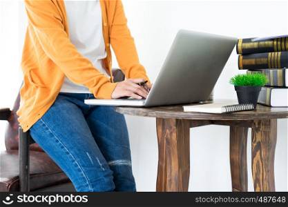 Attractive Young beautiful entrepreneur Woman smiling and looking at laptop screen, Working from Home