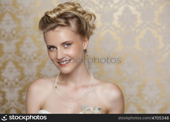 Attractive young blonde bride with beautiful wedding hairstyle