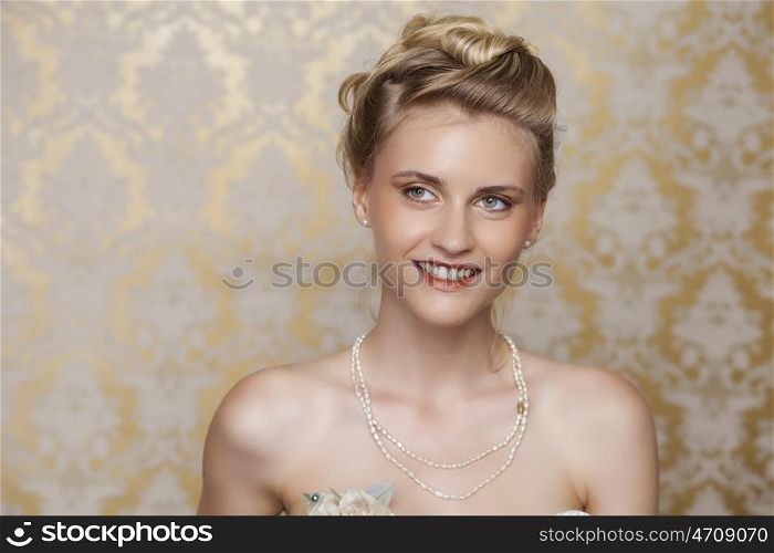 Attractive young blonde bride with beautiful wedding hairstyle