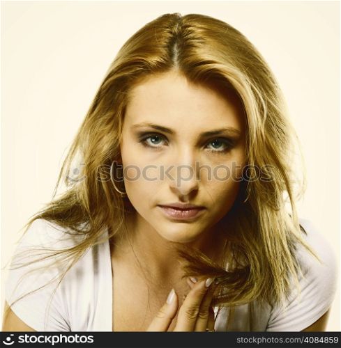Attractive young blonde woman long hair portrait, studio shot