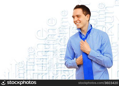 Attractive young business man binding his blue tie