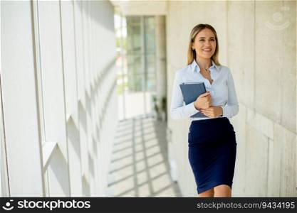 Attractive  young business woman walking on stairs in the office hallway