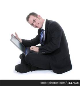 Attractive Young Businessman Sitting On Floor With Laptop.