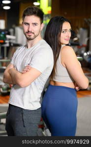 Attractive young couple after workout in fitness gym. High quality photo. Attractive young couple after workout in fitness gym.