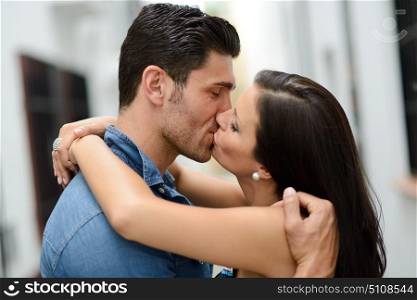 Attractive young couple kissing in the street