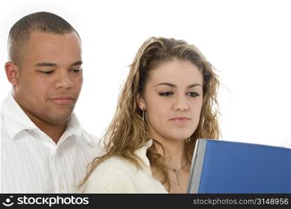 Attractive young couple looking at laptop computer. Shot in studio over white.