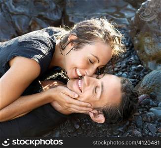 Attractive Young Couple on Rocks Smiling