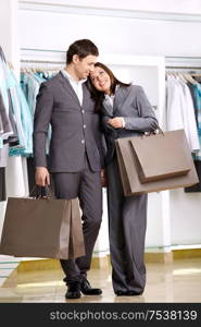 Attractive young couple with purchases in shop