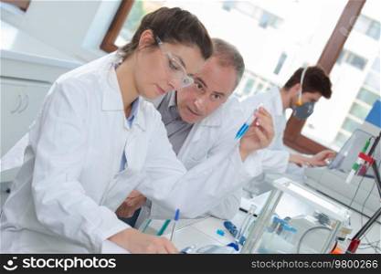 attractive young female scientist and her senior male supervisor