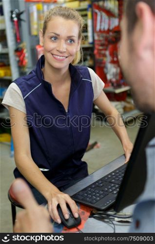 attractive young female worker talkin to customer