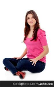 Attractive young girl in pink sitting on the floor isolated on a white background