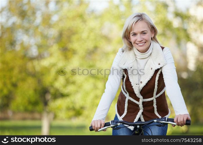 Attractive young girl on a bicycle in the park