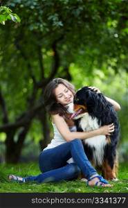 Attractive young girl playing with dog