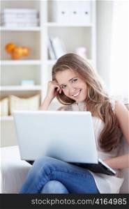 Attractive young girl with a laptop at home