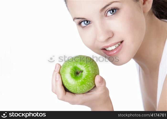 Attractive young girl with an apple isolated