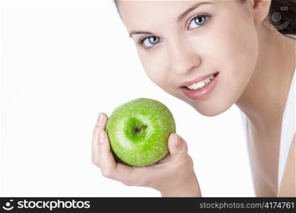 Attractive young girl with an apple isolated