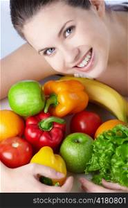 Attractive young girl with fruits and vegetables