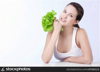 Attractive young girl with lettuce on white background