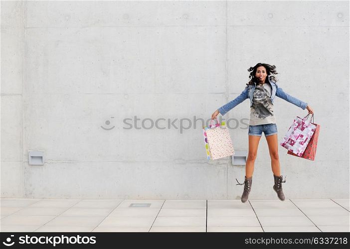 Attractive young girl with shopping bags in the street