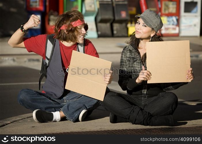 Attractive Young Man and Woman with Blank Cardboard Signs