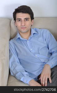 attractive young man lying and relaxing on the couch